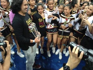 SHS Pep Squad coach Randell San Gregorio proudly holds the three trophies his teams won in Day of the National Cheerleading Championships