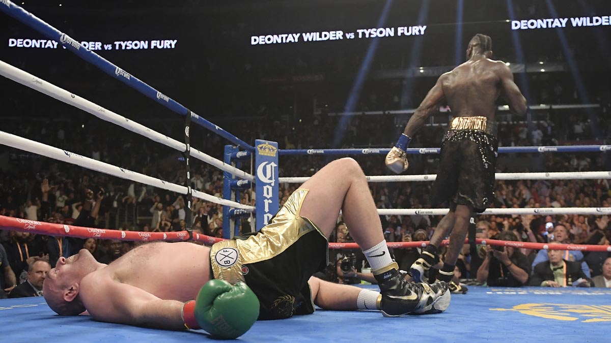 Fury dominates but gets knocked down twice and Wilder keeps title with