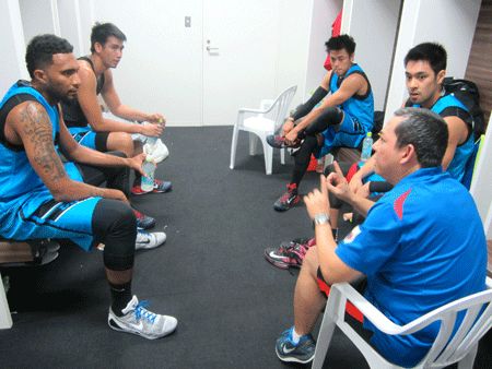 Manila West huddles with coach John Flores.