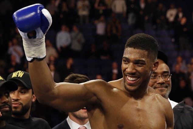 Anthony Joshua stops Carlos Takam in 10th round to retain heavyweight titles
