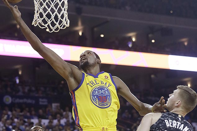 Curry exits early with ankle injury but Durant catches fire late to rally Warriors past Spurs