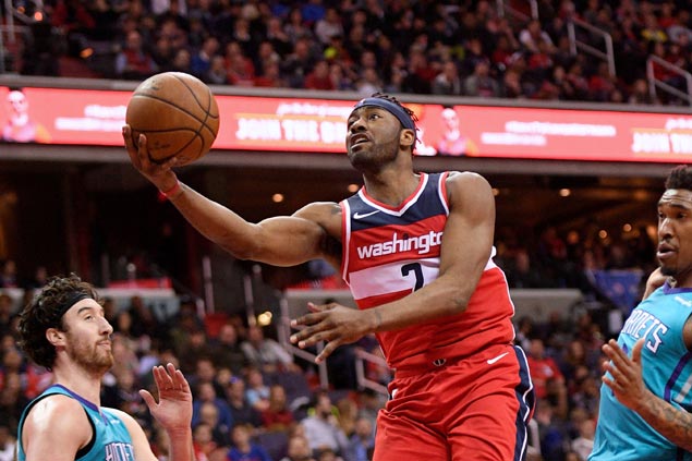 John Wall solid in return from injury layoff as Wizards down Hornets to clinch playoff berth