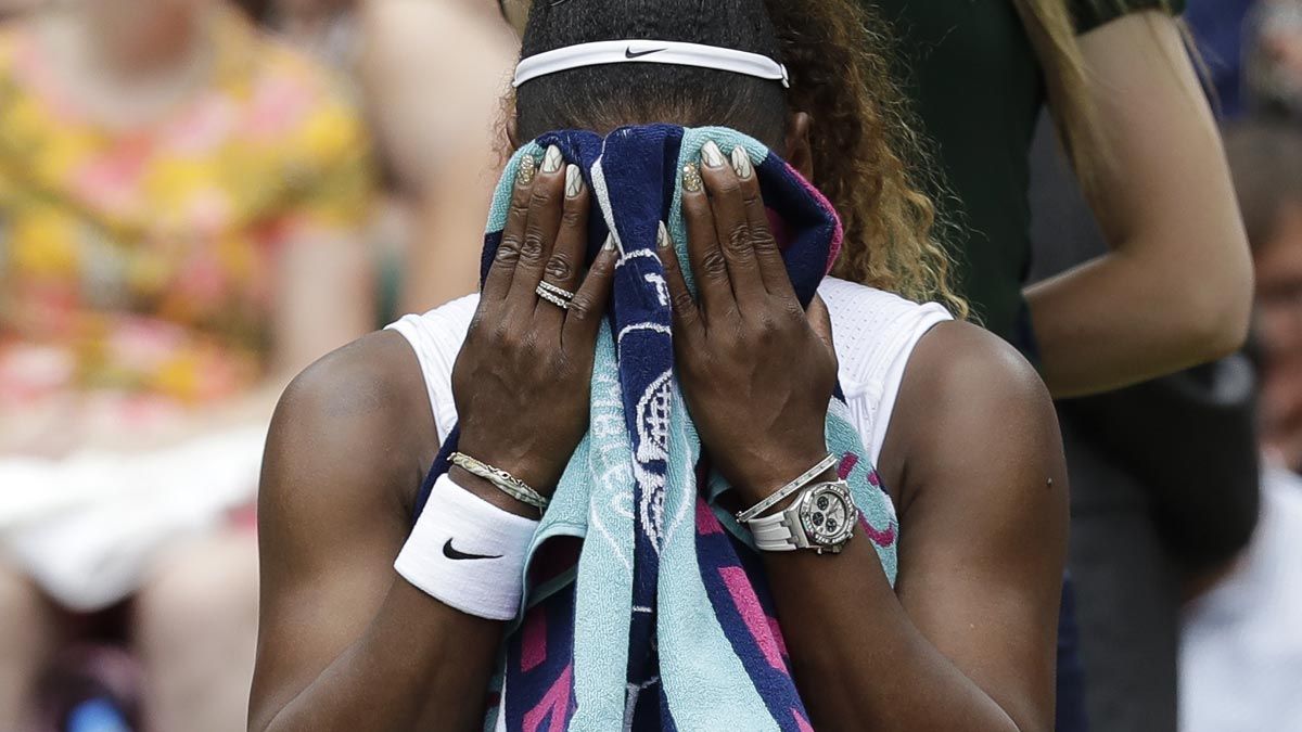 Serena Williams wiping her sweat with a towel