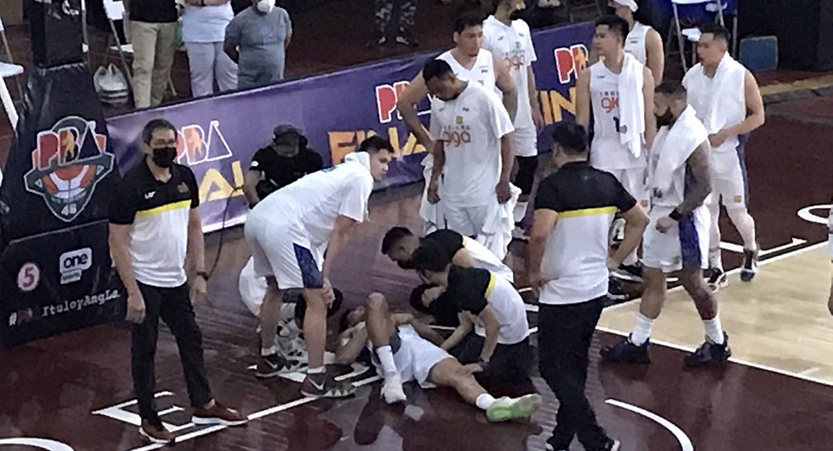 Troy Rosario is attended to by TnT medical staff after the bad fall in Game 3.