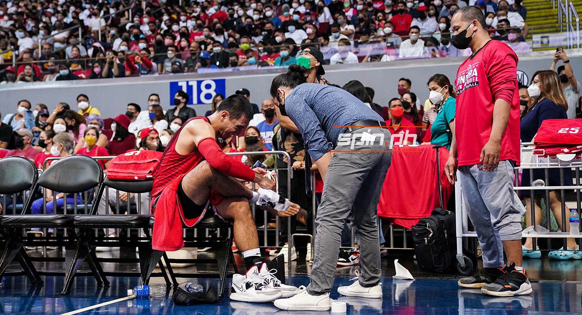 Ginebra guard LA Tenorio's injured ankle gets treatment on the bench.