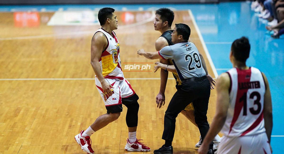 Jericho Cruz and RR Pogoy are separated by the referee after a heated exchange.