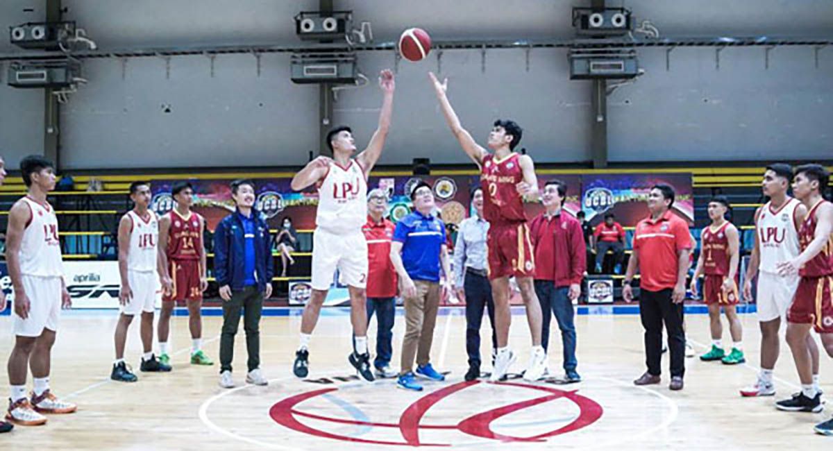 PG Flex Linoleium owner Nelson Guevarra makes the ceremonial toss during the opening game between Tagaytay’s Guang Ming College and Lyceum of the Philippines-Batangas Thursday at the Paco Arena in Manila. Also shown are PG Flex’s Neil Guevarra, tournament