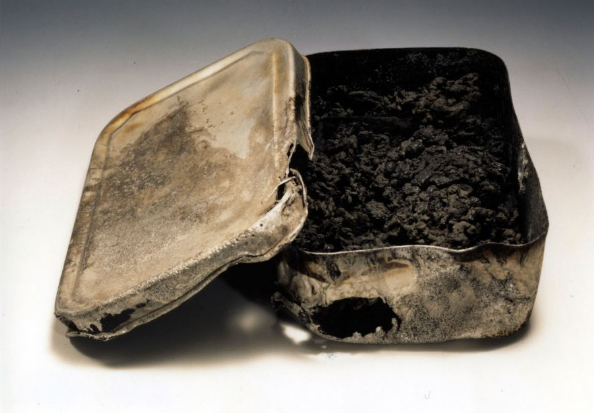 A tin lunch box and its contents, burned after the Hiroshima Bombing