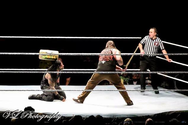 WWE fan arrested in Canada for throwing a briefcase at wrestler Roman ...